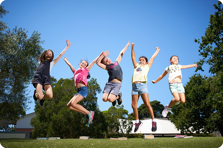 A group of girls jumping in the air from excitement. 